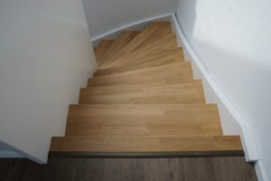 Escalier design entre limon sans fixation visible, garde-corps en prolongement du limon laqué en blanc