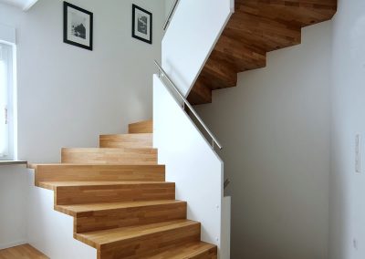 Escalier design à Colmar: marches en chêne abouté et garde-corps en bois plein laqué blanc
